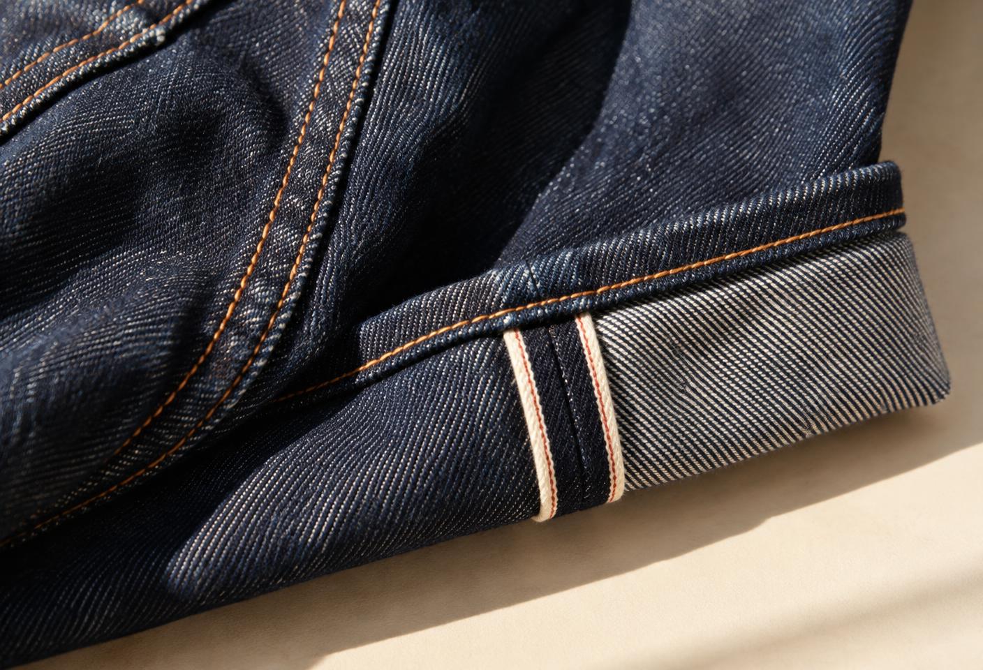 Macro detail of indigo denim and copper stitching